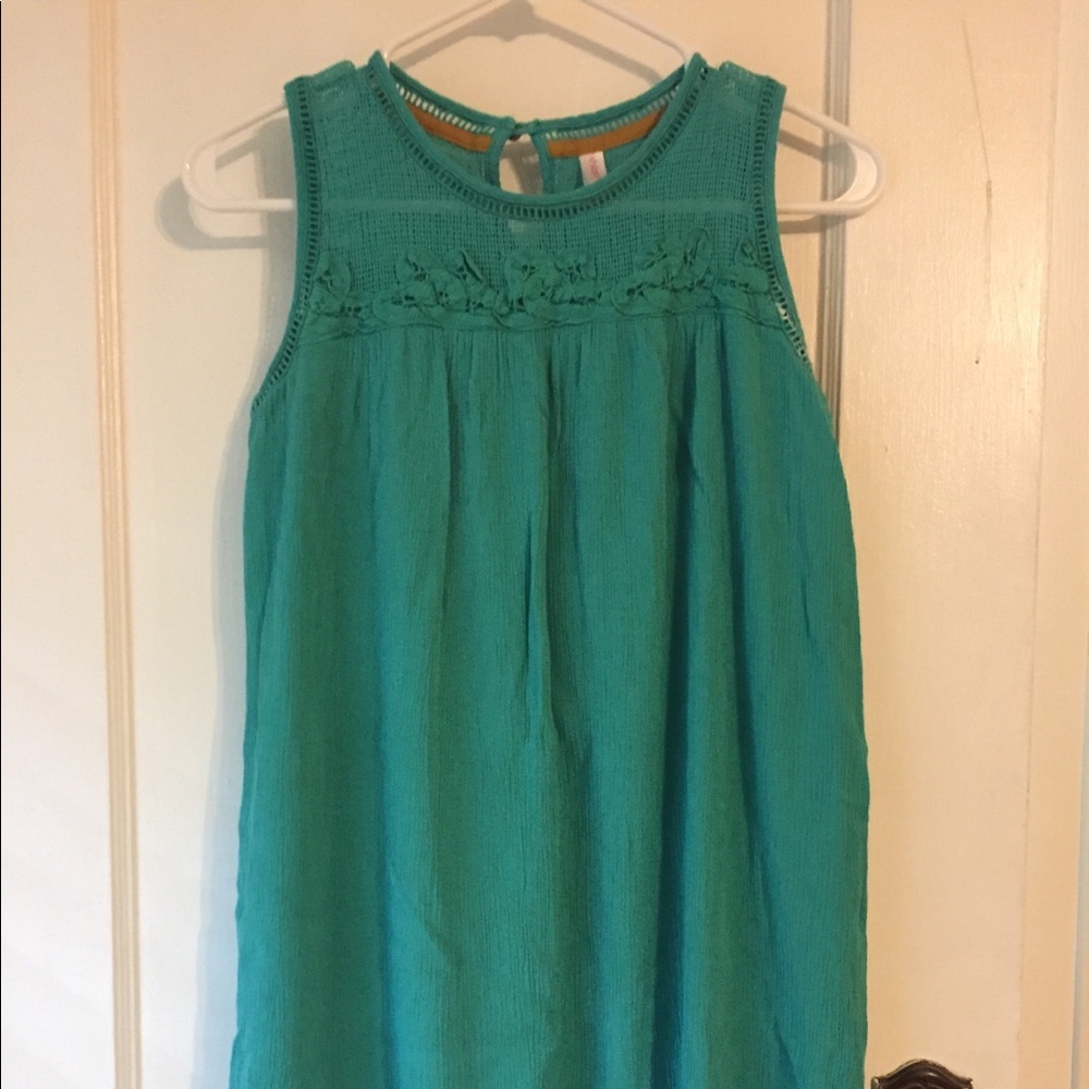 Green dress with sheer neckline.